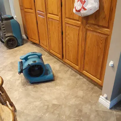 Air mover drying kitchen cabinets and tile in Fullerton