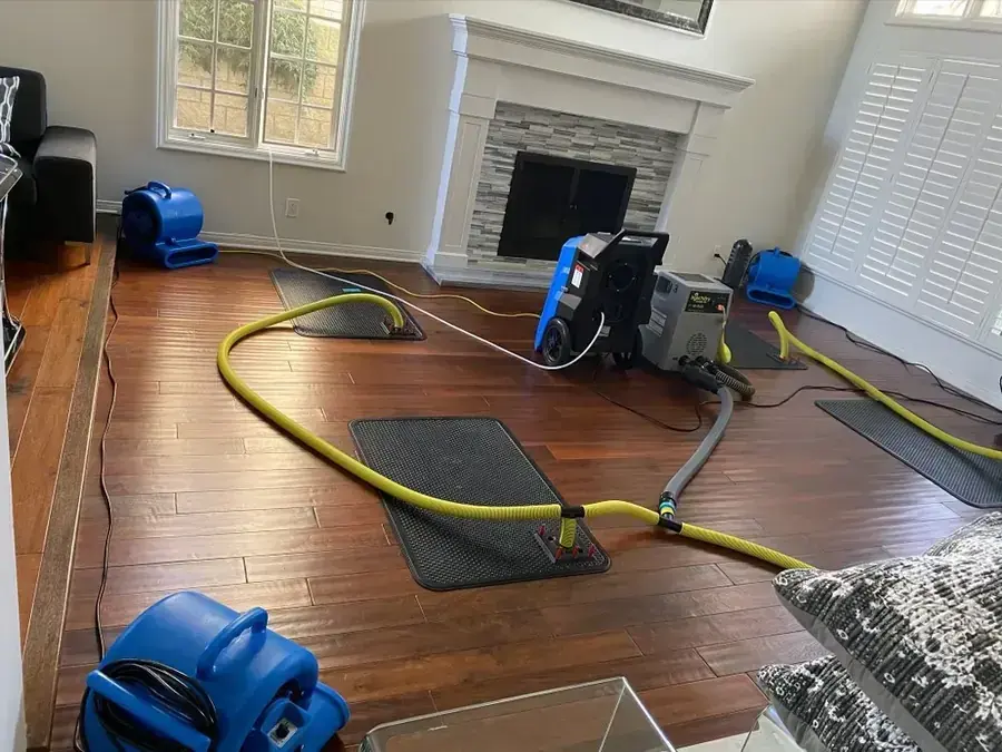 Extraction wand pulling standing water off a flooded Fullerton floor